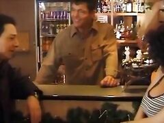 Sexy customer in black stockings fucked by two guys in a bar